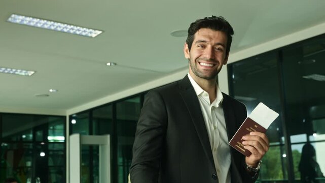 Cheerful business passengers walk into the passport control and ticketing counters to check their documents before check-in and register at the baggage screening machine for preparation and security.