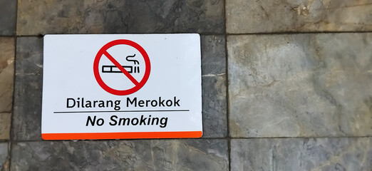 No smoking sign. A non-smoking area on a stone wall. The area is not for smoking.