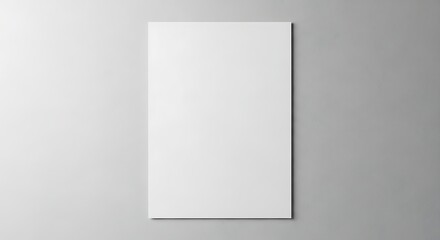 Clean blank white poster mockup against a textured gray wall offers simple elegance.
