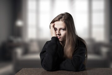 thoughtful young person in a dark room