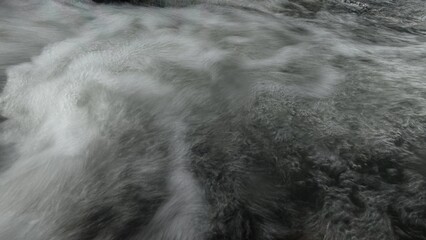 Scenic river with flowing water, rocks, trees, underwater view and sun reflection