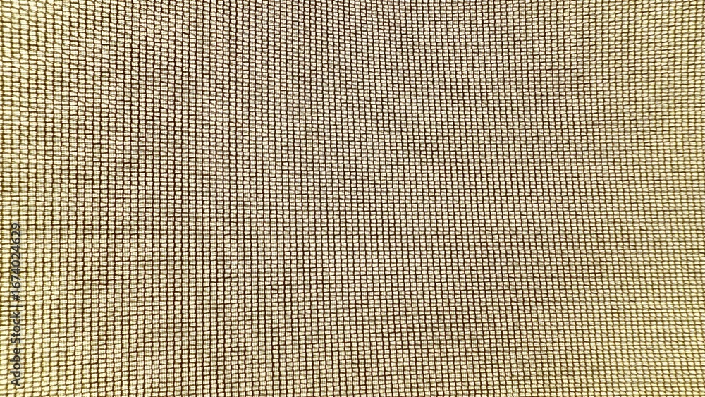 Aufkleber golden mesh grid fabric closeup with illuminated woven texture pattern for modern design background 