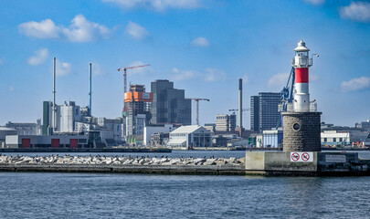 Aarhus, Denmark-August 15, 2025: Lighthouse With Modern Industry Skyline