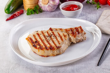 Tasty hot grilled bone steak served sauce