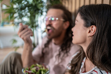 Couple enjoying a healthy salad meal together at home