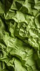 Fototapeta premium Crumpled green wrapping paper forms abstract texture background