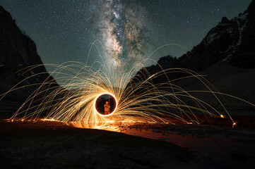 Light Painting with Red Orb Under Starry Sky