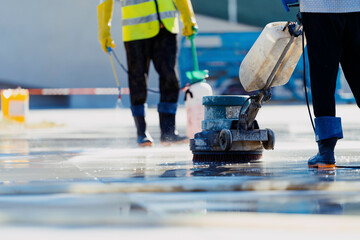 woker cleaning floor with machine