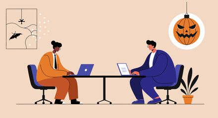 Two professionals work on laptops in an office decorated for Halloween, combining business tasks with festive seasonal atmosphere and team collaboration.