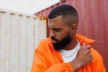 Portrait of stylish african american man wearing windbreaker jacket in port  © Dmytro Hai