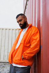 Portrait of stylish african american man in windbreaker jacket standing in port  © Dmytro Hai