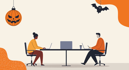 Diverse professionals work on laptops in a modern office adorned with Halloween decor like a pumpkin and bat, combining holiday spirit with productivity.