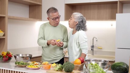 Asian senior couple happy cooking healthy food modern kitchen lifestyle vibrant vegetables fresh fruits family home - Powered by Adobe