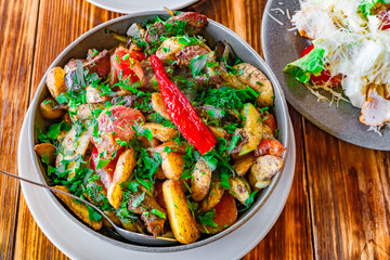 meat stew with potatoes and vegetables on dining table