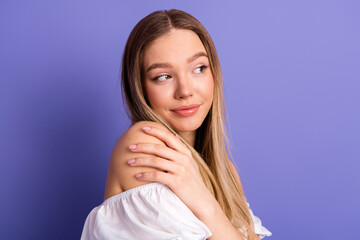 Beautiful young woman posing with a charming smile on violet background, showcasing casual fashion...