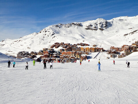 Skiers on a ski slope at Val Thorens, 3 Valleys ski resort in winter, snowy landscape in the Alps, France