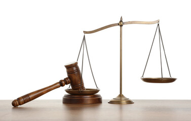 Golden scales of justice and gavel on wooden table against white background