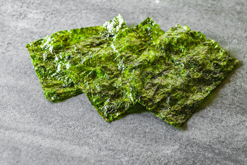 dried green nori leaves on table, selective focus