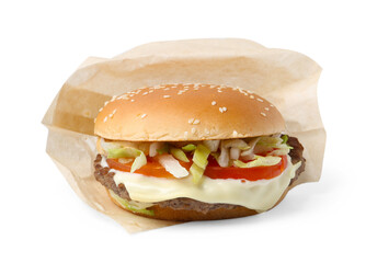 One delicious burger with cheese, tomato, lettuce and patty in takeaway package isolated on white. Tasty fast food