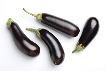 Many fresh eggplants on white background, flat lay
