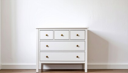 White wooden dresser with five drawers and round metal knobs — minimalist design with straight lines and tapered legs