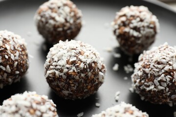 Tasty chocolate candies with nuts on plate, closeup