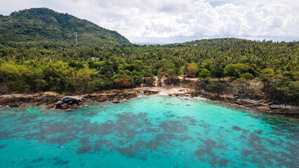 Aerial view of Racha Yai Island or Koh Raya, a beautiful tropical island in Andaman sea with turquoise clear water along the shore. A popular destination for summer vacation in Phuket, Thailand.
