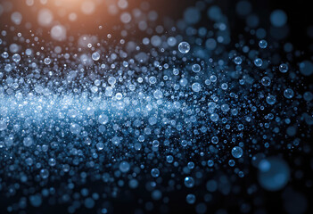 Abstract blue bubbles with blurred bokeh effect and orange glow on a dark background