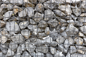 View of gabion with mesh and stones.