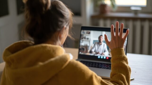 hispanic teen girl school college student distance learning waving hand studying with online teacher on laptop screen elearning zoom video call videoconference class with tutor over shoulder view no