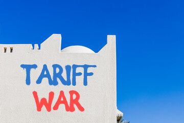 Trade tariff war symbol. Concept word Tariff war on beautiful white wall. Beautiful blue sky...