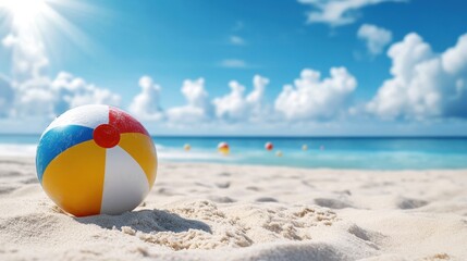 Obraz premium Colorful beach ball resting on sandy shore with ocean waves and bright blue sky in the background.