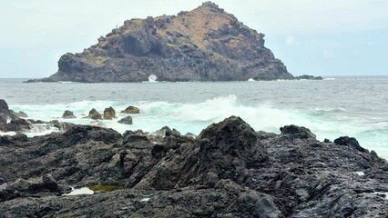 A Serene Coastal Landscape Featuring Rocky Shores and a Beautiful Island View Beyond