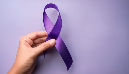 purple ribbon held in a hand against a pastel background