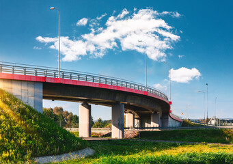 Curved Overpass with Concrete Pillars under Blue Sky