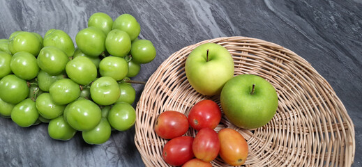 fresh green apples in a basketFruits and vegetables on table