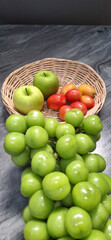 Basket and fresh fruits on  table