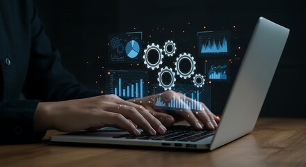 Close up of a person s hands typing on a laptop with a glowing blue digital interface showing charts and gears above the keyboard
