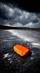 Orange Rock on Black Sand Beach During Gray Storm