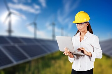Portrait of a young female engineer at solar panel farm.