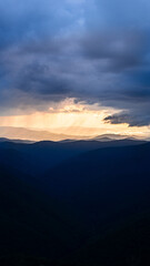 Fototapeta premium sunbeams before or after rain, thunderstorms, play of light in the mountains