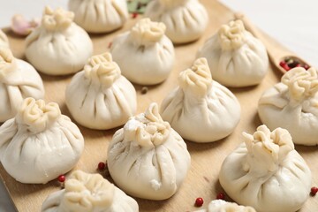 Fototapeta premium Uncooked khinkalis (dumplings) and spices on table, closeup