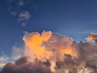detail of the cloud top of convective tropical clouds in golden sunshine during sunrize
