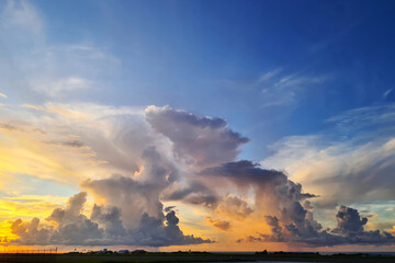 convective tropical clouds in golden sunshine during sunrise on a caribbean island