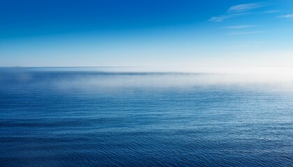 Obraz premium serene seascape with calm water on a foggy morning