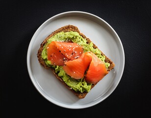 toast with avocado cream and smoked salmon over black background top view