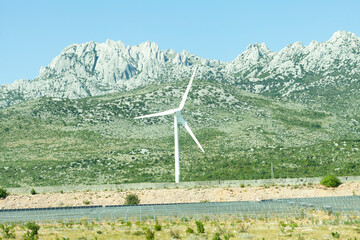 Wind turbine against mountain backdrop