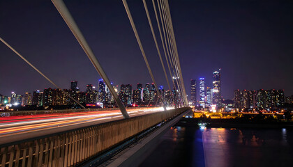 Fototapeta premium Night View of City Skyline from Illuminated Bridge