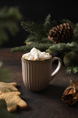 Christmas coffee with marshmallow and cookies as snowman in brown cup on dark background. Xmas cozy...