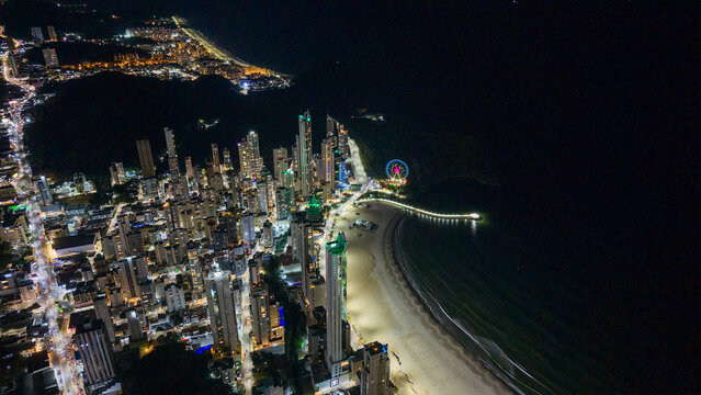 Balneario Camboriu Barra Norte aerial night view with illuminated pier, FG Big Wheel and skyline, Santa Catarina, Brazil.